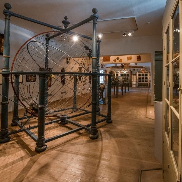 Interior view of the Cabinet of Artefacts and Natural Curiosities at the Francke Foundations featuring a central world model and historical display cabinets from the Baroque curiosity chamber.